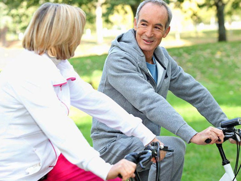 Elderly couple riding bicycles