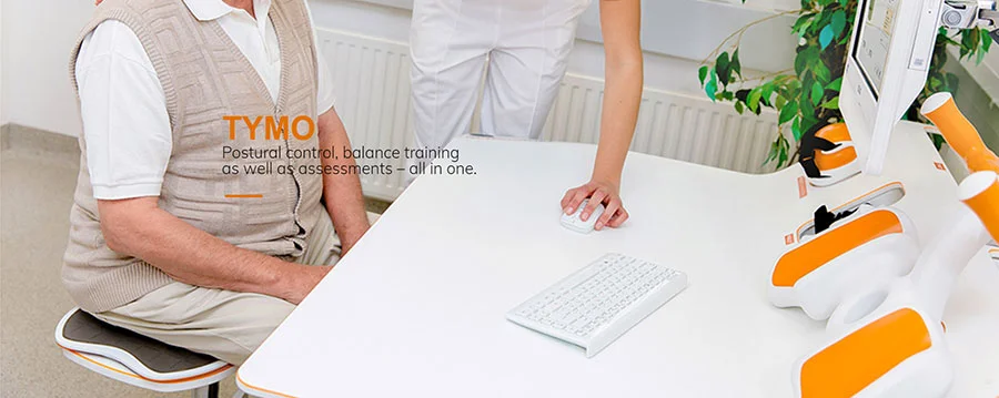 Woman sitting at computerised Tymo balance assessment device