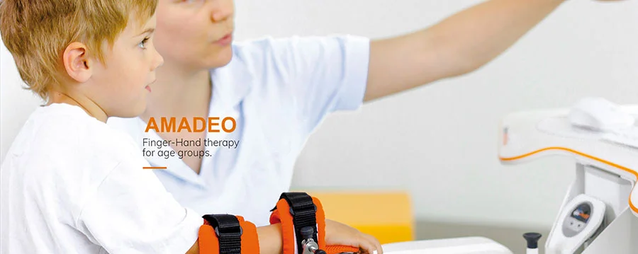 Boy using Amadeo finger-hand therapy device