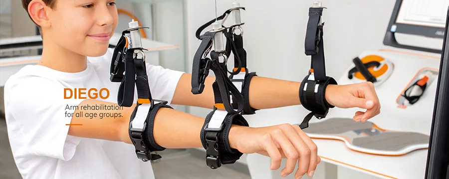 Boy using Diego arm rehabilitation therapy device