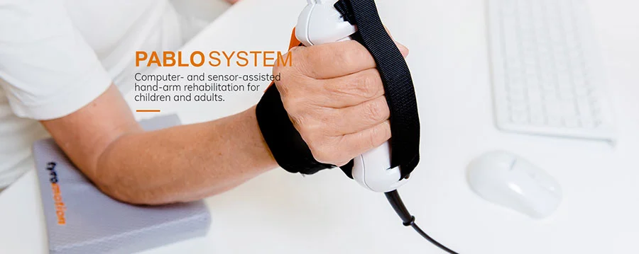 Man holding Pablo hand-arm rehabilitation device