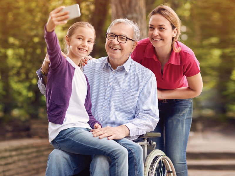Alliance Rehabilitation and Community Based Rehabilitation Services (CBRS) Happy man in wheelchair with family