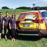 Staff next to car outside Ingham