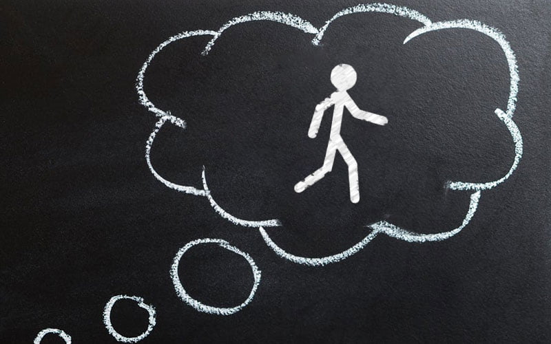 Tilting one’s perspective chalk drawing of a thought bubble with stick-figure walking